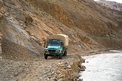 33 Truck Driving On Narrow Road Next To Chongphu Chu River On Drive To Kharta Tibet